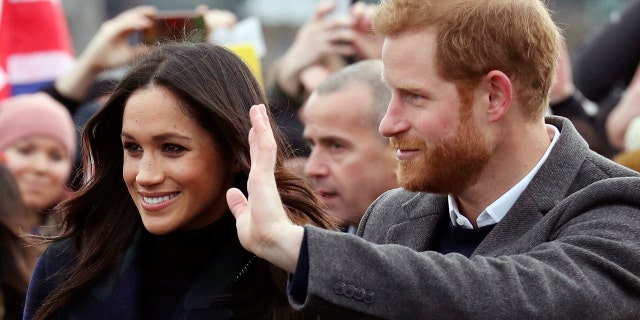 Britain's Prince Harry and Meghan Markle during a walkabout with Britain's Prince Harry on the esplanade at Edinburgh Castle, Scotland, Tuesday, Feb. 13, 2018.