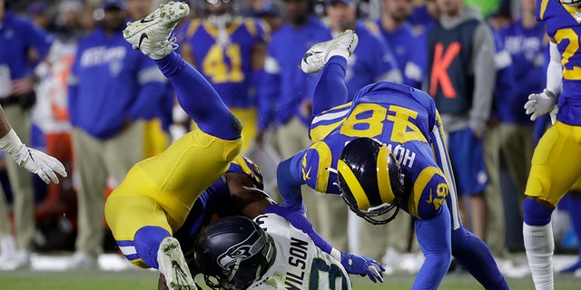 Seattle Seahawks quarterback Russell Wilson (3) is sacked by Los Angeles Rams linebacker Obo Okoronkwo, left, and linebacker Travin Howard during the second half of an NFL football game Sunday, Dec. 8, 2019, in Los Angeles. (AP Photo/Marcio Jose Sanchez)