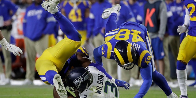 Seattle Seahawks quarterback Russell Wilson (3) is sacked by Los Angeles Rams linebacker Obo Okoronkwo, left, and linebacker Travin Howard during the second half of an NFL football game Sunday, Dec. 8, 2019, in Los Angeles. (AP Photo/Marcio Jose Sanchez)