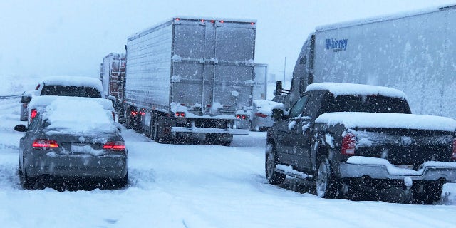 This photo provided by Johnny Lim shows a snow covered northbound I-15 in the Cajon Pass between the San Bernardino Mountains and the San Gabriel Mountains in Southern California on Thursday, Dec. 26, 2019.
