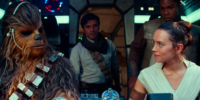 This image released by Disney/Lucasfilm shows, from left, Joonas Suotamo as Chewbacca, Oscar Isaac as Poe Dameron, Daisy Ridley as Rey and John Boyega as Finn in a scene from 