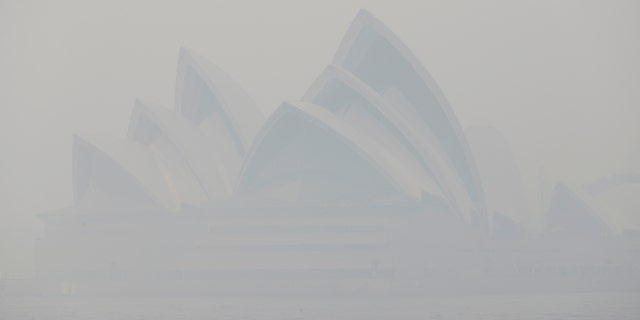 Thick smoke from wildfires shrouds the Opera House in Sydney, Australia, Tuesday, Dec. 10, 2019.