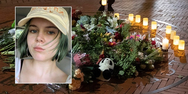 People pause and place a candle at a makeshift memorial for Tessa Majors inside the Barnard campus. (AP Photo/Mary Altaffer)