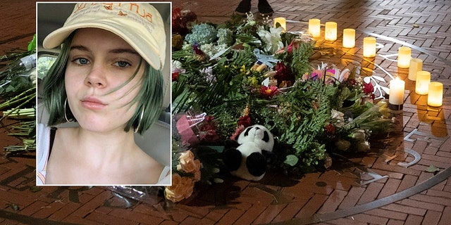 People pause and place a candle at a makeshift memorial for Tessa Majors inside the Barnard campus. (AP Photo/Mary Altaffer)