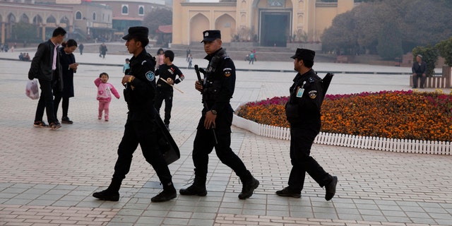 Uighur security personnel patrol near the Id Kah Mosque in Kashgar in western China's Xinjiang region. Classified documents, leaked to a consortium of news organizations, lay out the Chinese government's deliberate strategy to lock up ethnic minorities to rewire their thoughts and even the language they speak. 