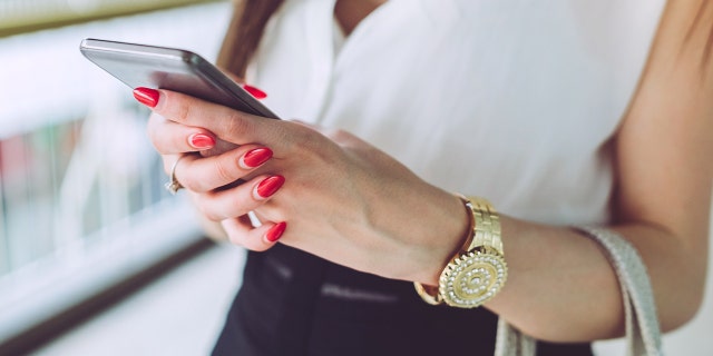 Woman texting on phone istock