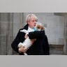 Britain's Prime Minister holds his dog Dilyn after voting in the general election at Methodist Central Hall, Westminster, London, Dec. 12, 2019. 