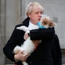 Britain's Prime Minister holds his dog Dilyn after voting in the general election at Methodist Central Hall, Westminster, London, Dec. 12, 2019. 