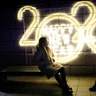 Seoul, South Korea: Women pose for a picture in front of a 2020 luminous sign during New Year's Eve celebrations. 