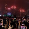 Hong Kong: New Year's fireworks light up the sky as protesters gather during a demonstration. (AP Photo/Lee Jin-man)