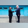 North Korean leader Kim Jong Un and President Donald Trump shake hands over the military demarcation line at the border village of Panmunjom in Demilitarized Zone, June 30, 2019.