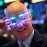New York: Stock trader John O'Hara tries on his New Year's 2020 party glasses at the New York Stock Exchange.  (AP Photo/Mark Lennihan)
