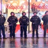 Members of the NYPD counterterrorism unit stand in the rain before sunrise in Times Square in New York City, Dec. 11, 2019. 