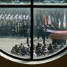 Police Honor Guard members framed through a window of Grace Church, fold a flag during the funeral of Houston Police Sgt. Christopher Brewster, in Houston, Dec. 12, 2019. 