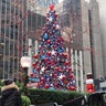 People look at the Christmas tree in FOX Square in New York City.