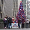 People stop by FOX Square to see the Christmas tree on display on Sixth Avenue in New York City.