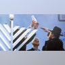 London, England: Mayor Sadiq Khan, center, watches the lighting of a menorah during the annual Menorah Lighting Ceremony, in Trafalgar Square.?