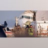 Police stand guard as rescuers assist on the site of a plane crashed near Almaty International Airport, outside Almaty, Kazakhstan, Friday, Dec. 27, 2019. 