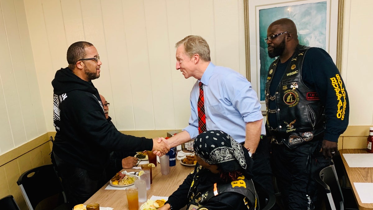 Tom Steyer chats with members of the Buffalo Soldiers bike gang at the Thunderbird Inn Buffet in Florence, S.C., Jan. 19. 