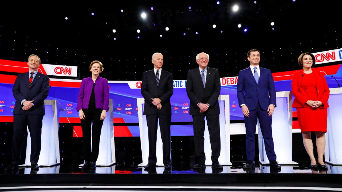 From left, Democratic presidential candidates businessman Tom Steyer, Sen. Elizabeth Warren, D-Mass., former Vice President Joe Biden, Sen. Bernie Sanders, I-Vt., former South Bend Mayor Pete Buttigieg, and Sen. Amy Klobuchar, D-Minn., stand on stage, Tuesday, Jan. 14, 2020, before a Democratic presidential primary debate hosted by CNN and the Des Moines Register in Des Moines, Iowa. (AP Photo/Charlie Neibergall)