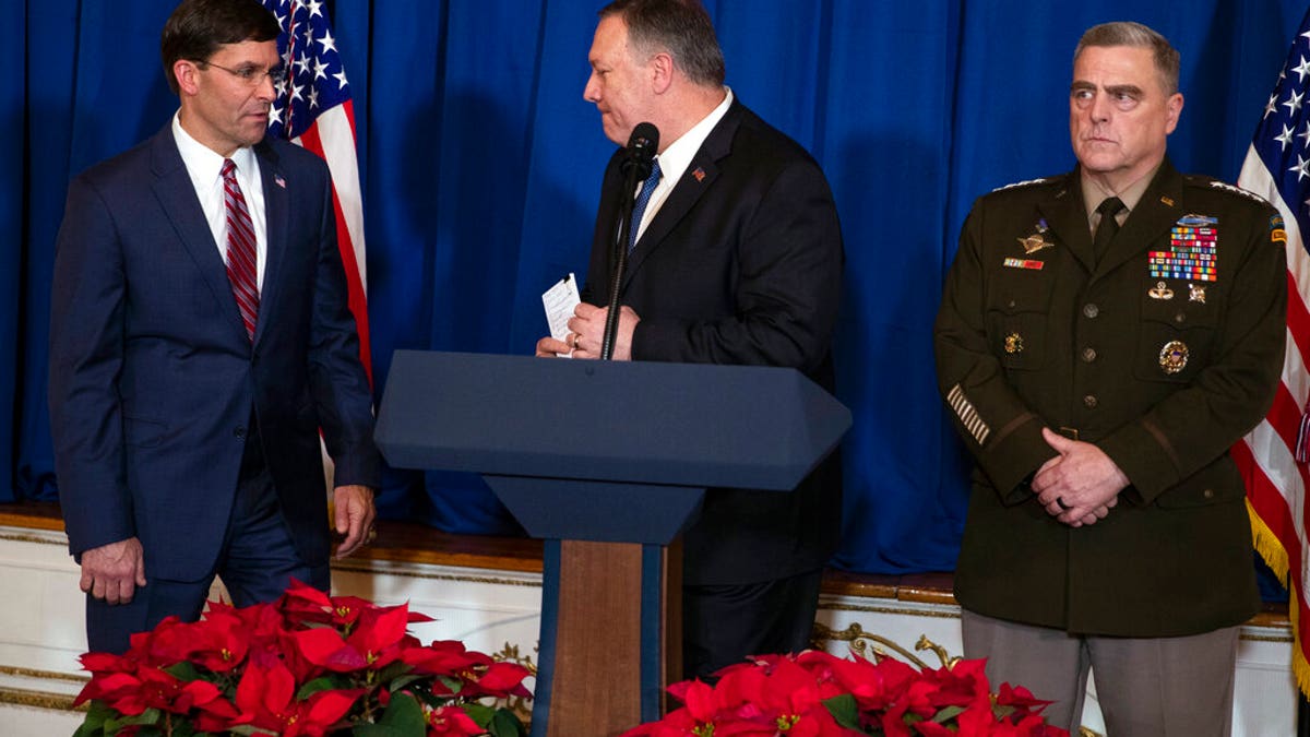 Secretary of State Mike Pompeo, center, Secretary of Defense Mark Esper, left, and Chairman of the Joint Chiefs of Staff Gen. Mark Milley deliver a statement on Iraq and Syria, at President Donald Trump's Mar-a-Lago property, Sunday, Dec. 29, 2019, in Palm Beach, Fla. (AP Photo/ Evan Vucci)