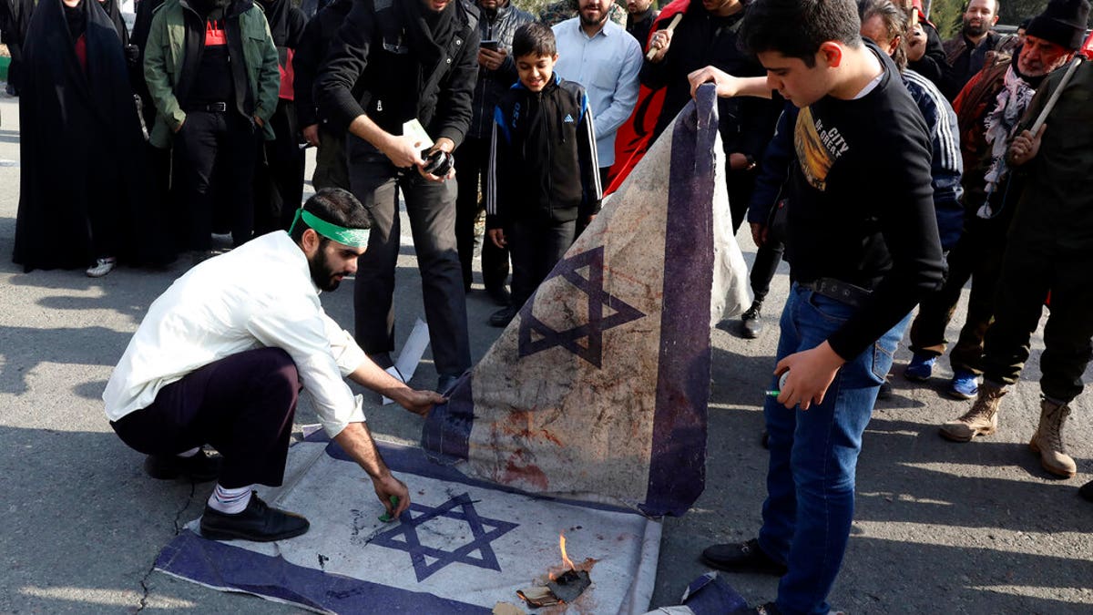 Protesters in Tehran burn representations of Israeli flag during a demonstration over the U.S. airstrike in Iraq that killed Iranian Revolutionary Guard Gen. Qassem Soleimani.