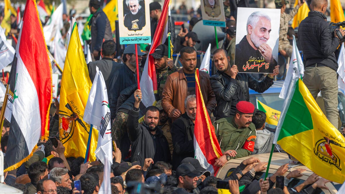 People attend the funeral of Iran's top general Qassem Soleimani and 9 Iranians and Iraqis, in Baghdad, Iraq, Saturday, Jan. 4, 2020. 