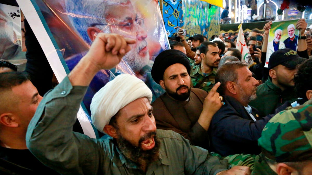 Mourners chant slogans against the U.S. during the funeral of Iran's top general Qassem Soleimani, and Abu Mahdi al-Muhandis, deputy commander of Iran-backed militias in Iraq known as the Popular Mobilization Forces, in the shrine of Imam Hussein in Karbala, Iraq, Saturday, Jan. 4, 2020.
