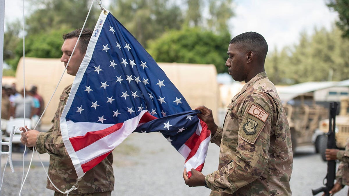 US Soldier Folding American Flag