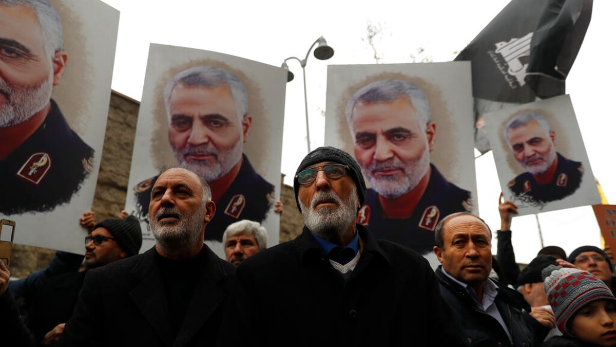 Protester gather during a demonstration against the killing of Iranian Revolutionary Guard Gen. Qassem Soleimani, seen in posters, close to United States' consulate in Istanbul, Sunday, Jan. 5, 2020. Iran has vowed "harsh retaliation" for the U.S. airstrike near Baghdad's airport that killed Soleimani, as tensions soar in the wake of the targeted killing.(AP Photo/Lefteris Pitarakis)