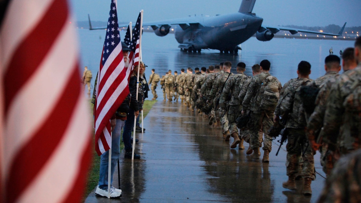 Paratroopers assigned to 1st Brigade Combat Team, 82nd Airborne Division walk as they prepare equipment and load aircraft bound for the U.S. Central Command area of operations from Fort Bragg, N.C., Jan. 4, 2020. (Spc. Hubert Delany III/U.S. Army via AP, File)