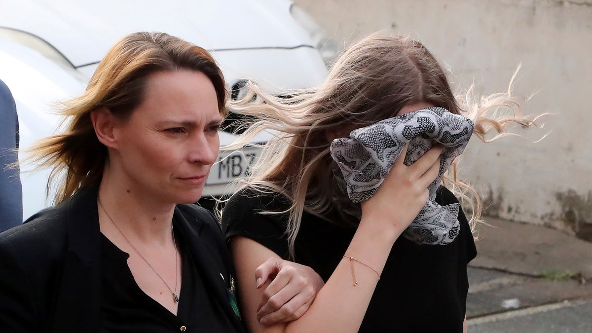 A 19-year-old British woman, right, that was found guilty of making up claims she was raped by up to 12 Israelis, arrives at Famagusta District Court with her mother for sentencing on Tuesday, Jan. 7, 2020. A Cyprus court handed a four-month suspended sentence to a 19-year-old British woman who was found guilty of public mischief for making up claims that she was raped by up to a dozen Israelis. (AP Photo/Petros Karadjias)