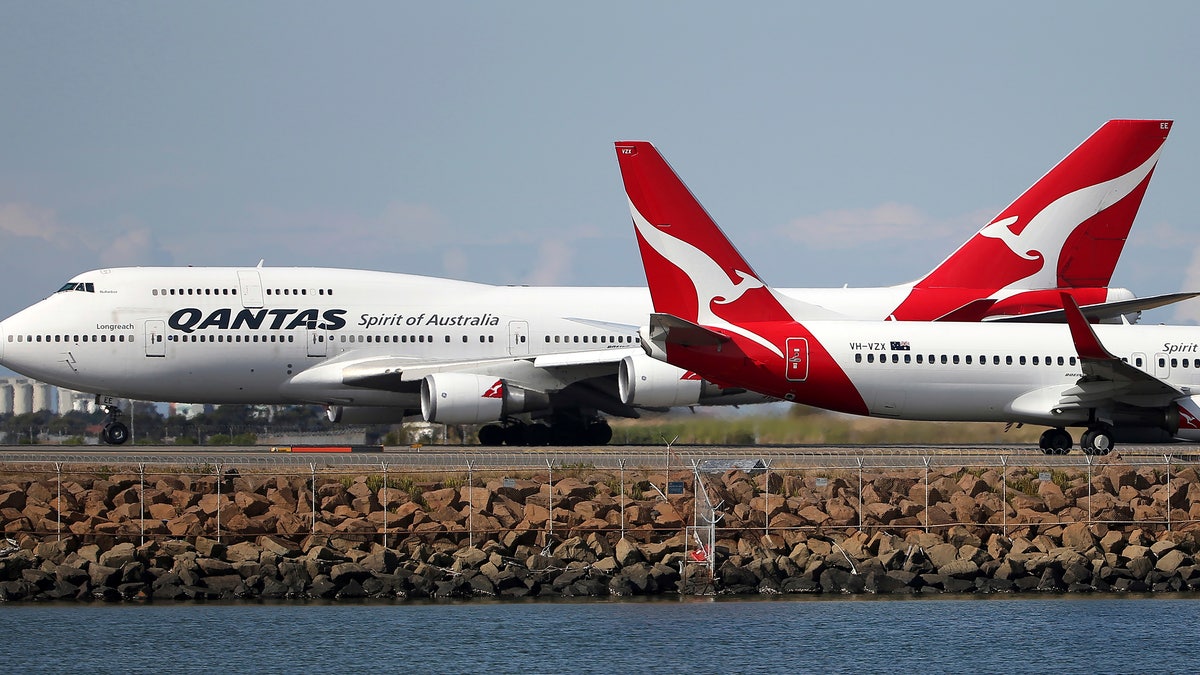 Two Qantas planes taxi on the runway at Sydney Airport in Sydney, Australia. Some commercial airlines have rerouted flights to the Middle East to avoid Iranian airspace, amid escalated tensions over the United States’ assassination of a prominent Iranian commander in Iraq. (AP Photo/Rick Rycroft, File)