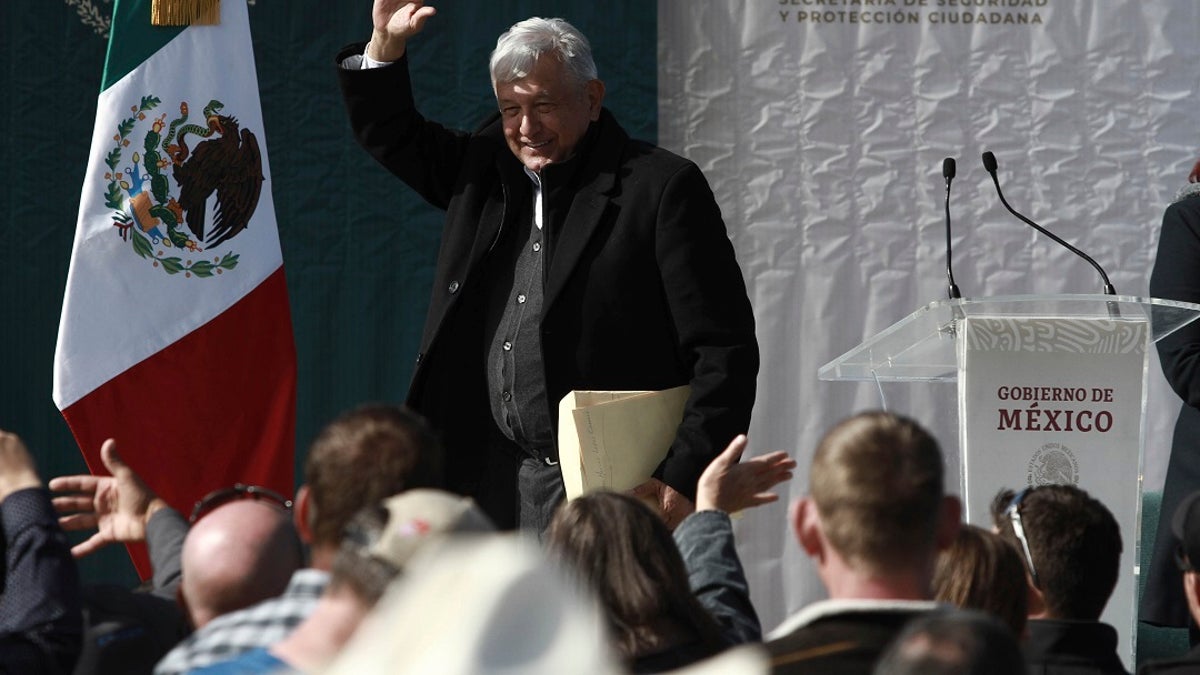 Mexico's President Andres Manuel Lopez Obrador waves to residents during his visit to the small town of La Mora, Sonora state, Mexico. Lopez Obrador said Sunday there is an agreement to establish a monument will be put up to memorialize nine U.S.-Mexican dual citizens ambushed and slain last year by drug gang assassins along a remote road near New Mexico. (AP Photo/Christian Chavez)