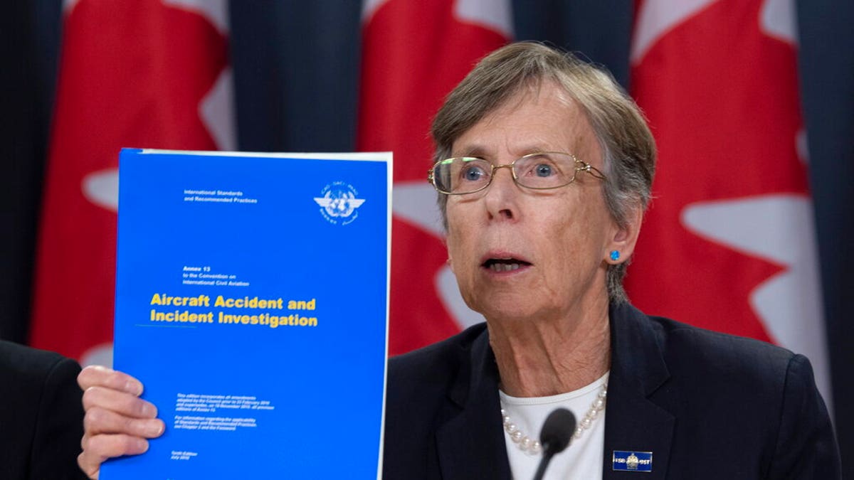Canada's Transportation Safety chair Kathy Fox holds up a document as she speaks about the Iran plane crash during a news conference in Ottawa, Monday. 