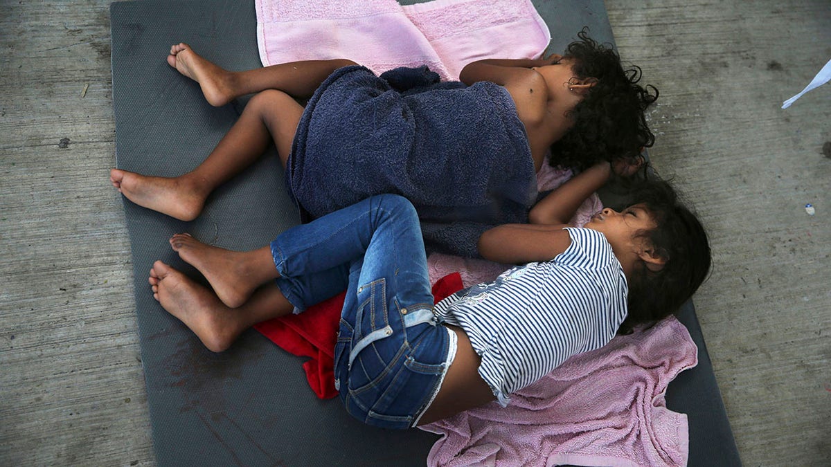 FILE - In this July 17, 2019, file photo, migrant children sleep on a mattress on the floor of the AMAR migrant shelter in Nuevo Laredo, Mexico. (AP Photo/Marco Ugarte, File)