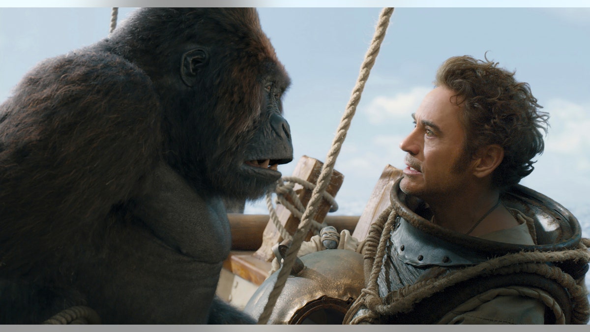 This image released by Universal Pictures shows Chee-Chee, voiced by Rami Malek, left, and Dr. John Dolittle, portrayed by Robert Downey Jr. in a scene from "Dolittle."
