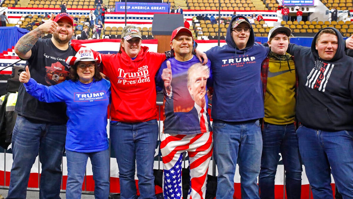 A group takes a picture in the front row as they arrive for a campaign rally with President Donald Trump Tuesday, Jan. 14, 2020, in Milwaukee. (AP Photo/Jeffrey Phelps)