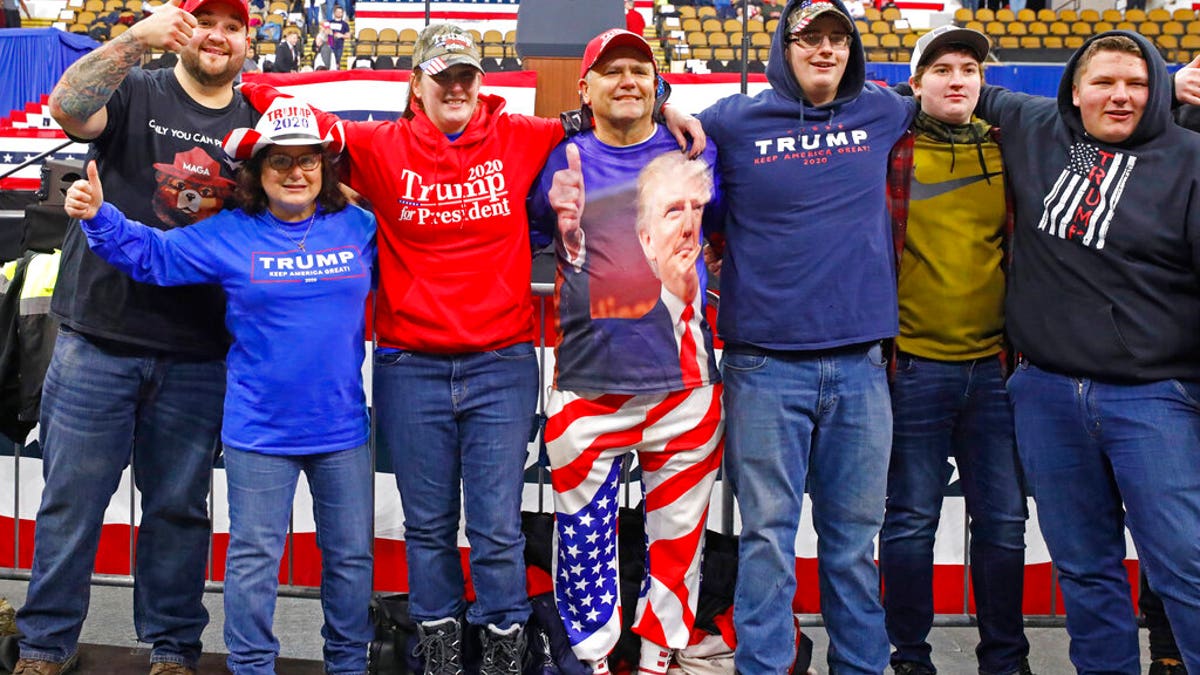 A group takes a picture in the front row as they arrive for a campaign rally with President Donald Trump Tuesday, Jan. 14, 2020, in Milwaukee. (AP Photo/Jeffrey Phelps)