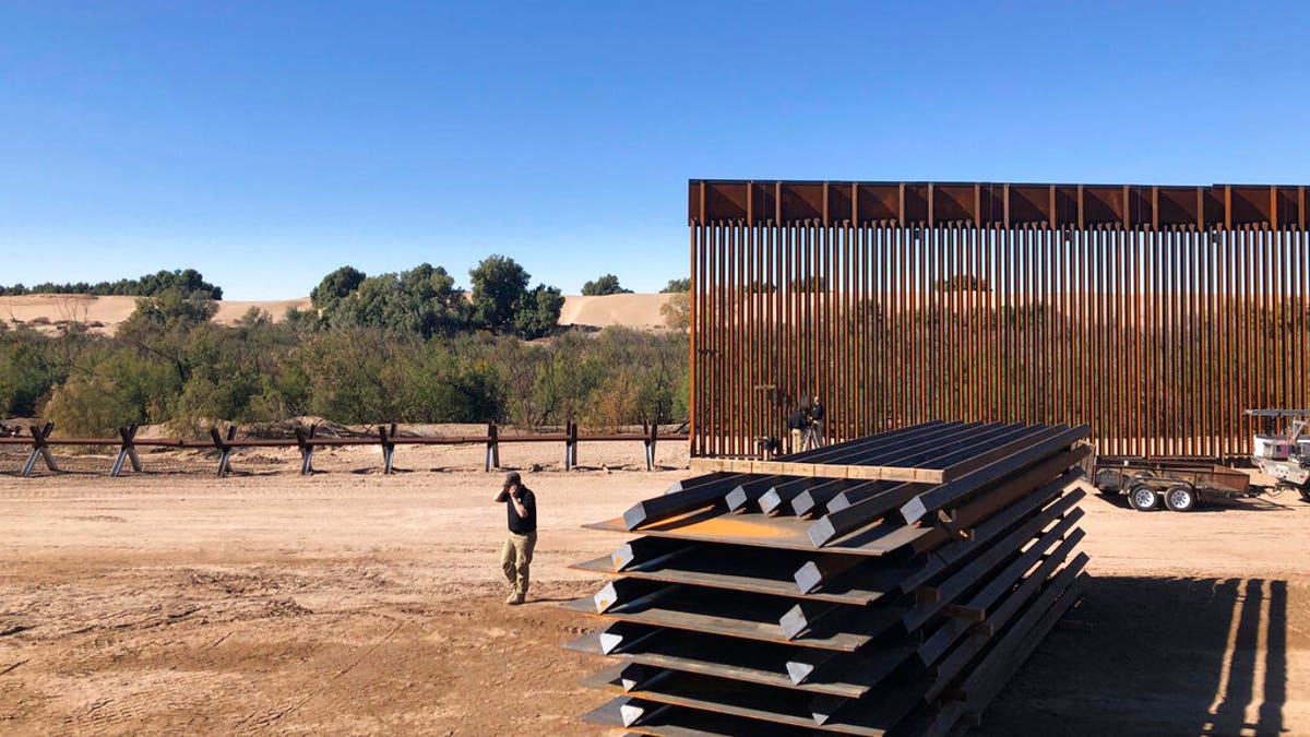 Crews working at a portion of border wall under construction in Yuma, Ariz.