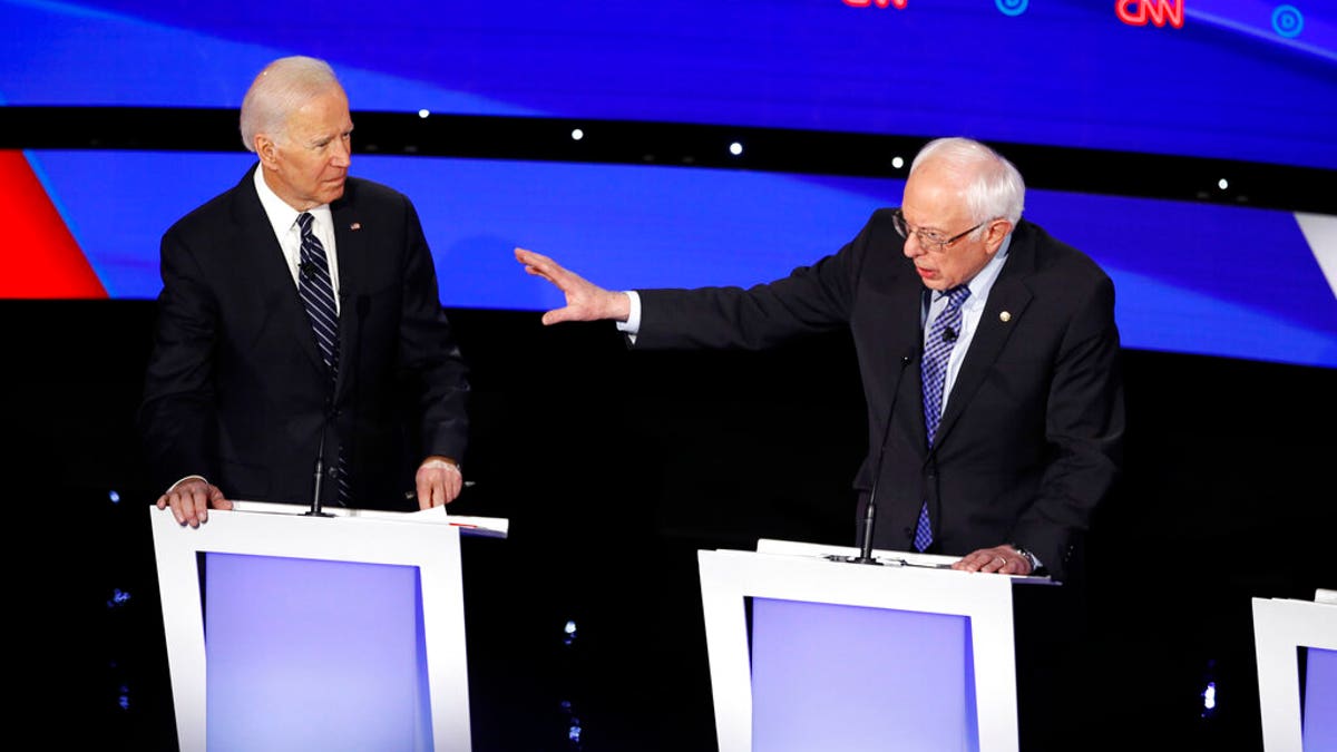 Democratic presidential candidate former Vice President Joe Biden, left, watches as Sen. Bernie Sanders, I-Vt., answers a question Tuesday, Jan. 14, 2020, during a Democratic presidential primary debate hosted by CNN and the Des Moines Register in Des Moines, Iowa. (AP Photo/Patrick Semansky)