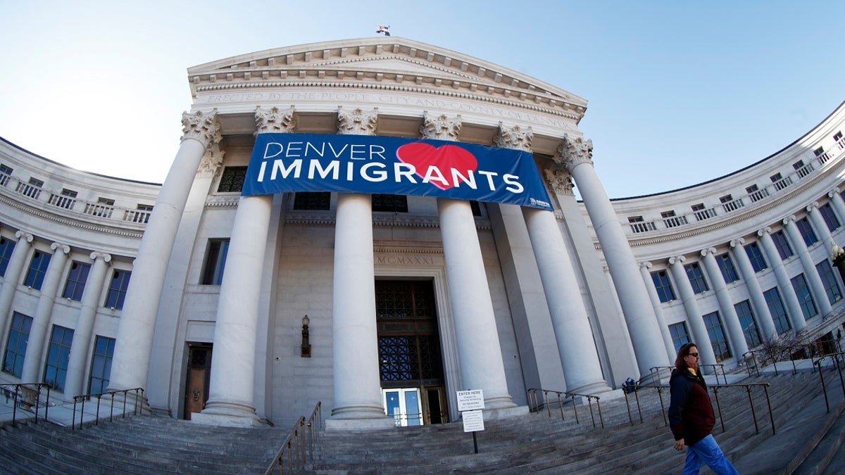 In this Feb. 26, 2018 file photo, a banner to welcome immigrants is viewed through a fisheye lens over the main entrance to the Denver City and County Building. U.S. Immigration and Customs Enforcement has subpoenaed Denver law enforcement for information on four foreign nationals wanted for deportation and could expand the unusual practice to other cities, an escalation of the conflict between federal officials and so-called sanctuary cities.  (AP Photo/David Zalubowski, File)