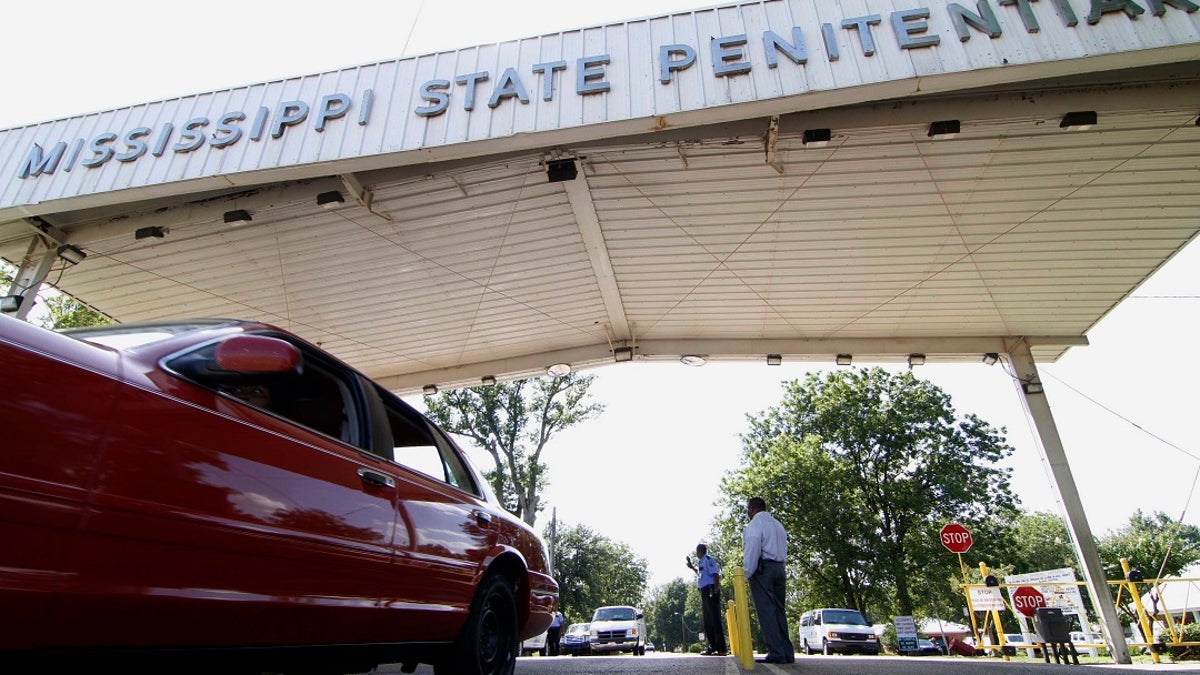Employees leave the front gate of the Mississippi State Penitentiary in Parchman, Miss. (AP Photo/Rogelio V. Solis, File)