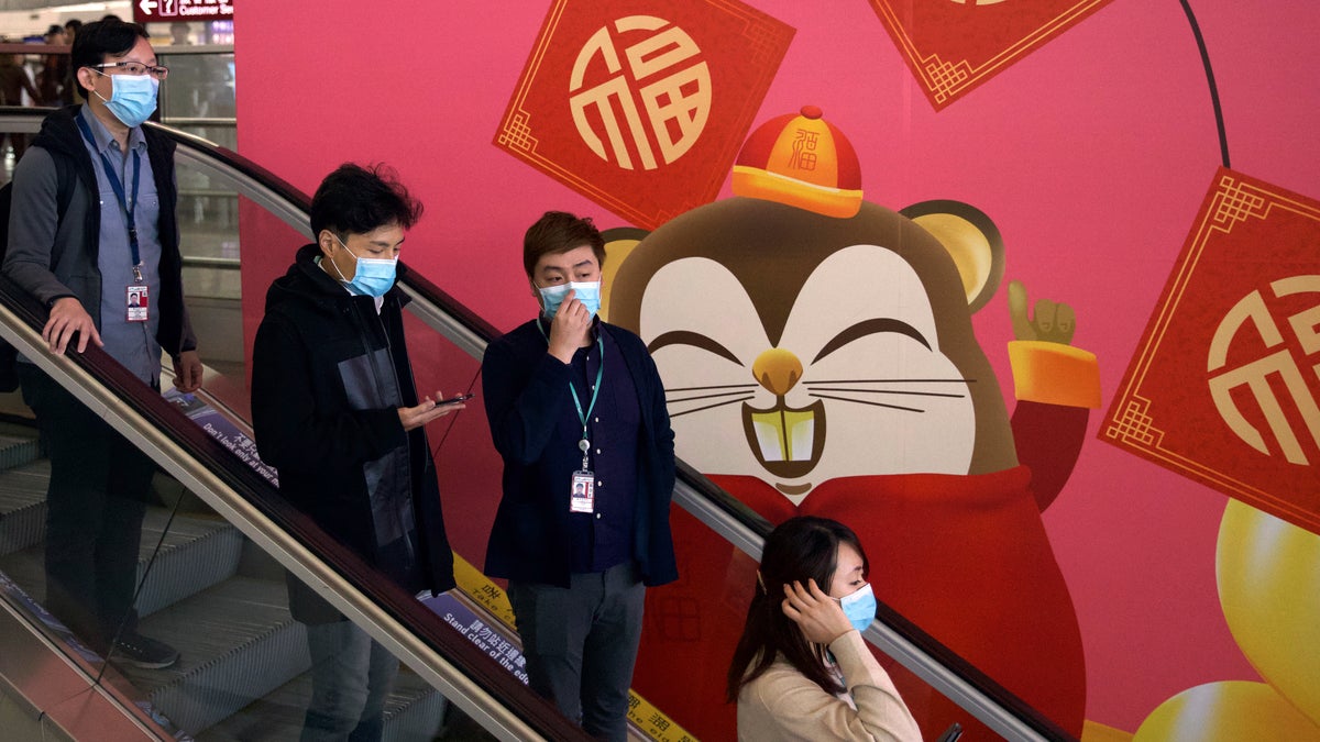 Face masks sold out and temperature checks at airports and train stations became the new norm as China strove Tuesday to control the outbreak of a new coronavirus that has reached four other countries and territories and threatens to spread further during the Lunar New Year travel rush.