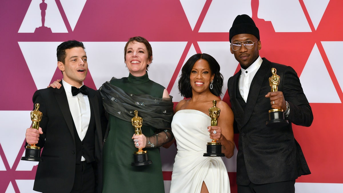 FILE - This Feb. 24, 2019 file photo shows Oscar winners, from left, Rami Malek, for best performance by an actor in a leading role for "Bohemian Rhapsody", Olivia Colman, for best performance by an actress in a leading role for "The Favourite", Regina King, for best performance by an actress in a supporting role for "If Beale Street Could Talk", and Mahershala Ali, for best performance by an actor in a supporting role for "Green Book", holding their awards in the press room at the Oscars in Los Angeles. The four will present awards during the Feb. 9 ceremony. 