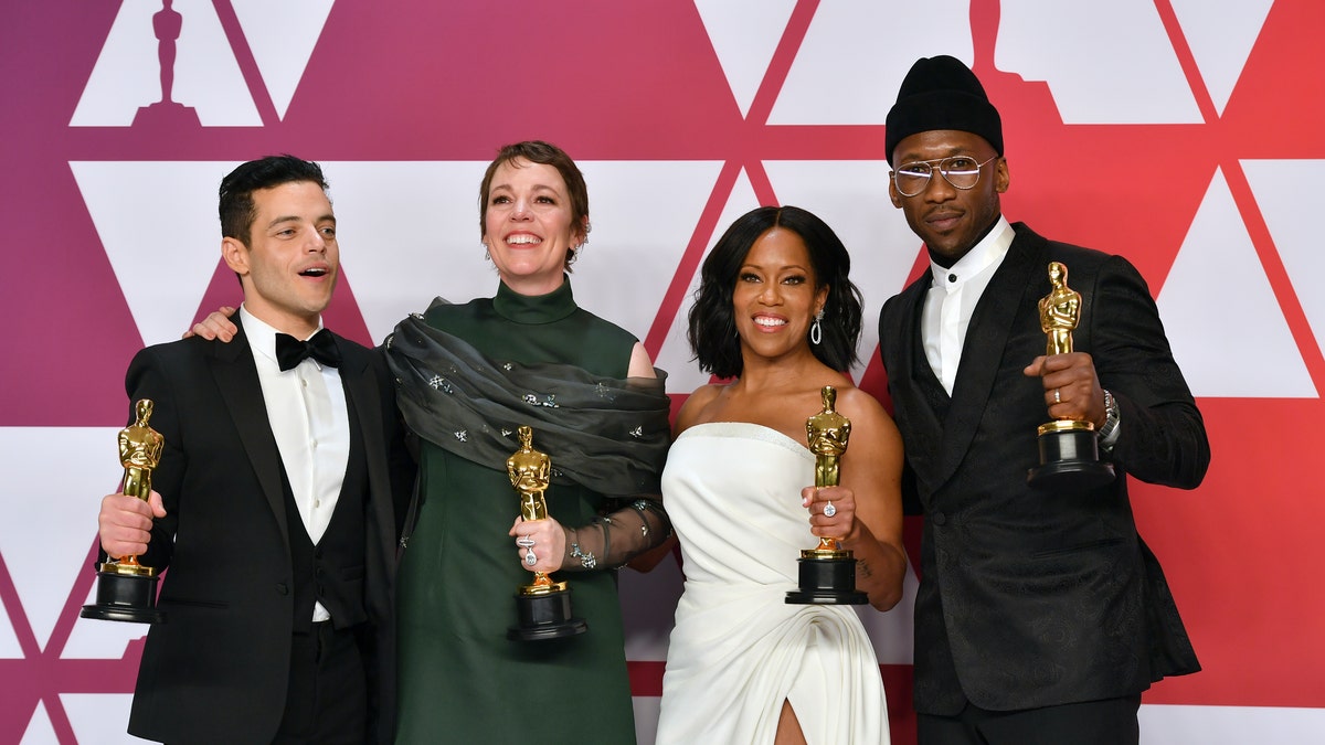 FILE - This Feb. 24, 2019 file photo shows Oscar winners, from left, Rami Malek, for best performance by an actor in a leading role for "Bohemian Rhapsody", Olivia Colman, for best performance by an actress in a leading role for "The Favourite", Regina King, for best performance by an actress in a supporting role for "If Beale Street Could Talk", and Mahershala Ali, for best performance by an actor in a supporting role for "Green Book", holding their awards in the press room at the Oscars in Los Angeles. The four will present awards during the Feb. 9 ceremony.?