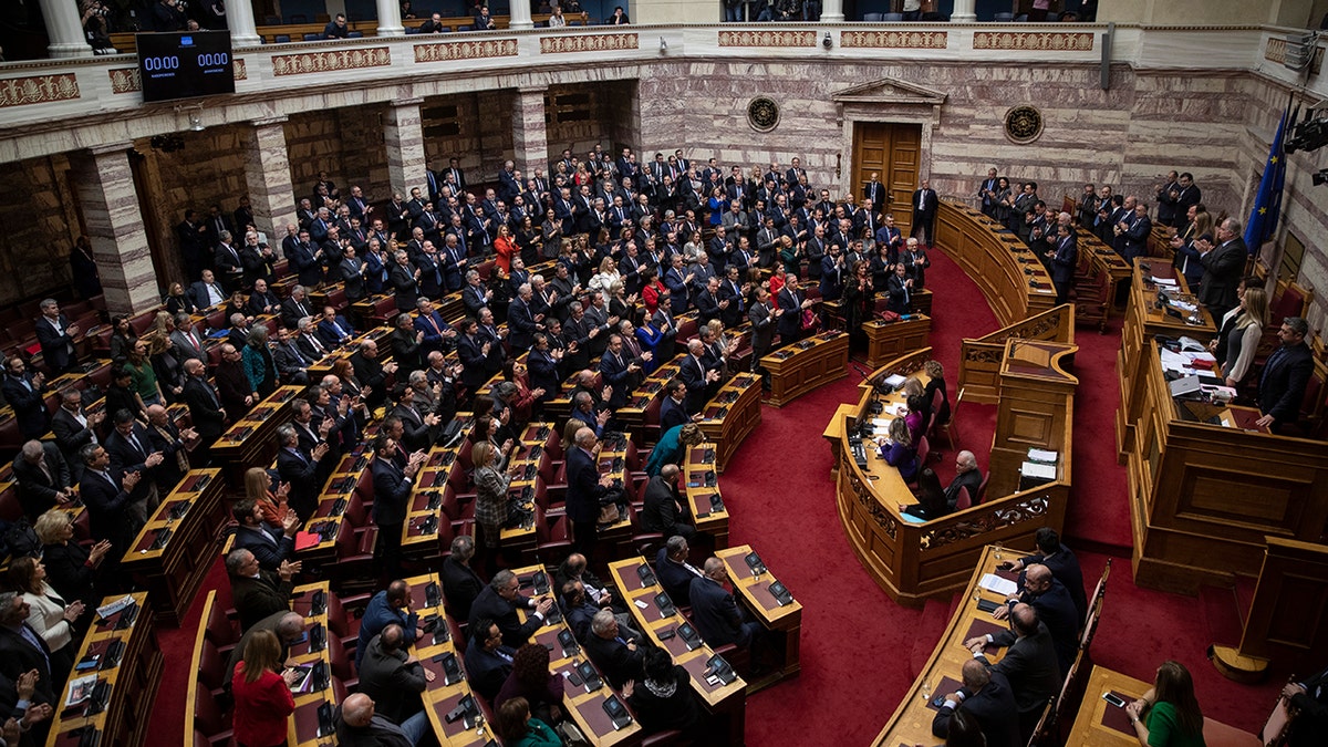 Greek lawmakers applaud during a parliamentary session to vote for the new Greek President, in Athens, on Wednesday, Jan. 22, 2019. High court judge Katerina Sakellaropoulou has been elected at Greece's first female president with an overwhelming majority in a parliamentary vote. (AP Photo/Petros Giannakouris)