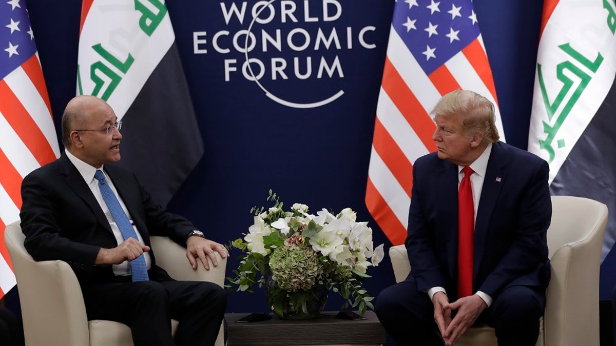 US President Donald Trump, right, attends a meeting with his Iraqi counterpart Barham Salih at the World Economic Forum in Davos, Switzerland on Wednesday. Trump's two-day stay in Davos is a test of his ability to balance anger over being impeached with a desire to project leadership on the world stage. (AP Photo/Evan Vucci)