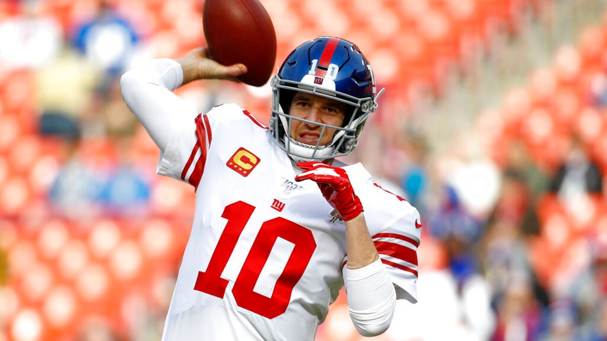 In this Dec. 22, 2019 file photo New York Giants quarterback Eli Manning works out prior to an NFL football game against the Washington Redskins in Landover, Md. (AP Photo/Patrick Semansky, file)