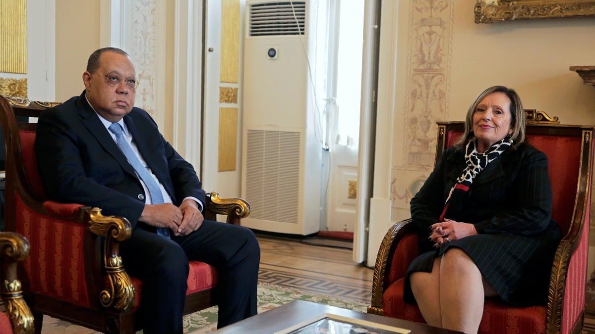 Angolan attorney general Helder Pitta Gros meets with his Portuguese counterpart Lucilia Gago, right, at the Portuguese attorney general's office in Lisbon on Thursday. Angola's attorney general arrived Thursday in Portugal to ask for help investigating a major corruption case targeting Isabel dos Santos, the billionaire daughter of Angola's former longtime leader. (AP Photo/Armando Franca)